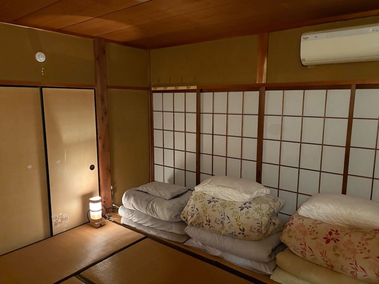 Bedding stacked against the shoji